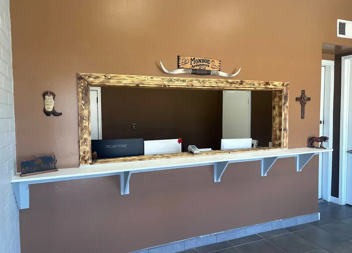 Front counter with rustic wood frame and longhorn decor in the Monroe shop lobby